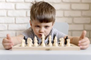 medium-shot-child-playing-chess